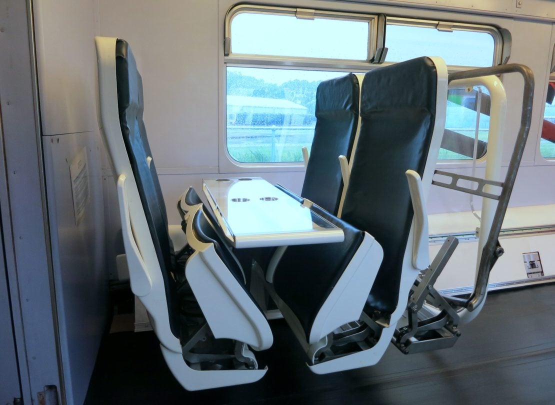 Folding seats in a train carriage