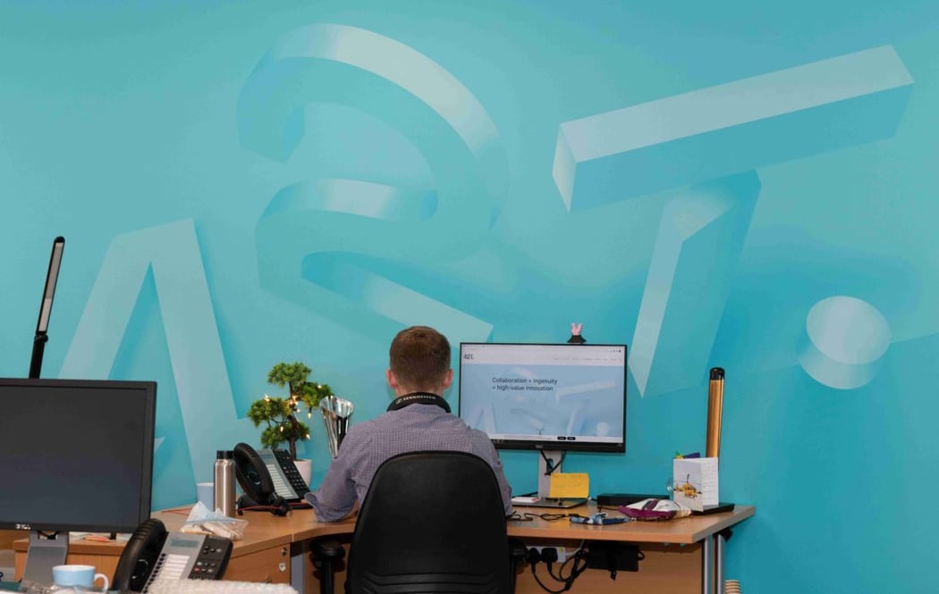 42T office wall with green graphic showing 3D 42T image