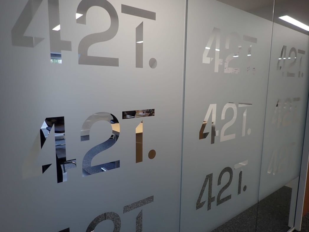 42T meeting room glass wall with frosted vinyl and 42T logos cut out