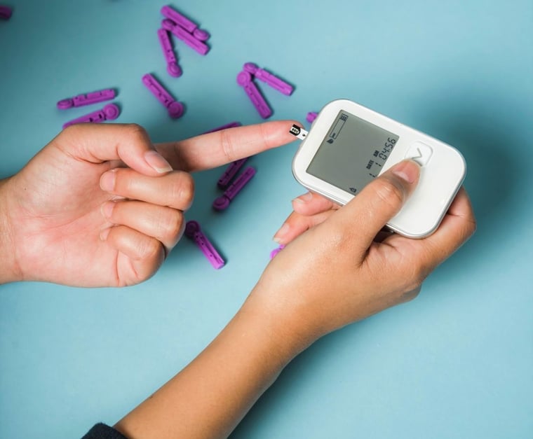 Woman checking blood sugar with glucometer