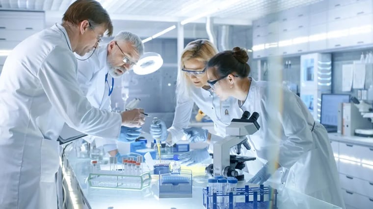 team-of-medical-research-scientists-work-on-a-new-generation-disease-cure-they-use-microscope